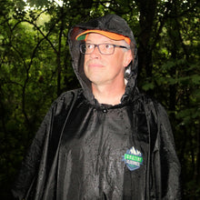 Man wearing a black rain poncho