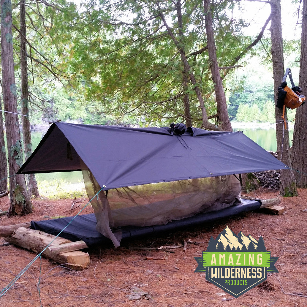 Rain poncho as tarp over simple cot